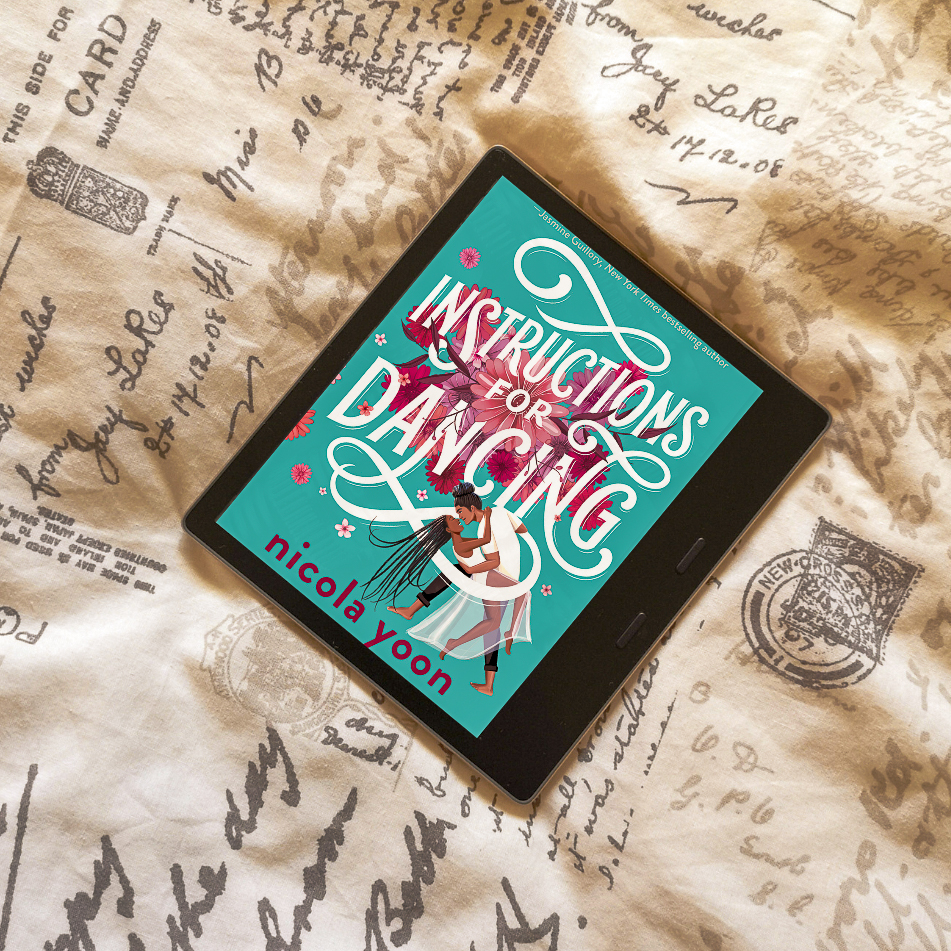 An e-reader wit the Instructions for Dancing book cover. The cover has a turquoise background with the title in white font, and in the bottom right there is a drawing of a heterosexual black couple.
